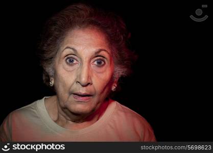 Close-up of an elderly woman with surprised expression