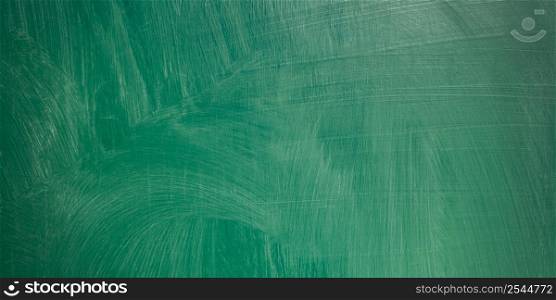close up of an empty school green chalkboard panorama background.