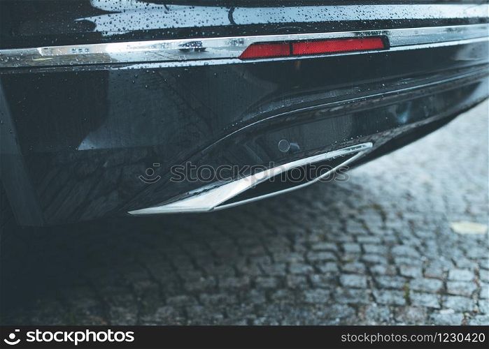Close up of an exhaust pipe of a car, environmental pollution