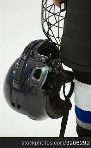 Close-up of an ice hockey player holding a helmet