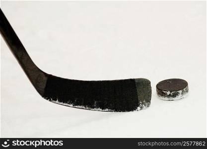 Close-up of an ice hockey stick with a hockey puck