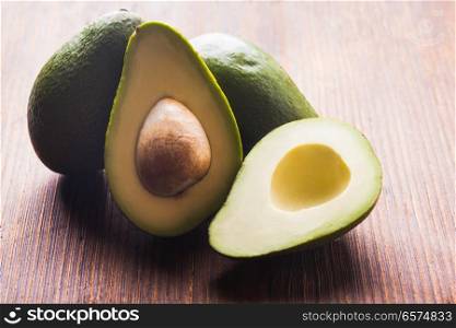 Close-up of an juicy organic avocado on wooden table. Healthy food concept