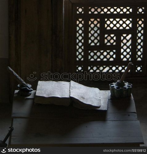 Close-up of an old book with ink well on table at Ben Youssef Madrasa, Medina, Marrakesh, Morocco