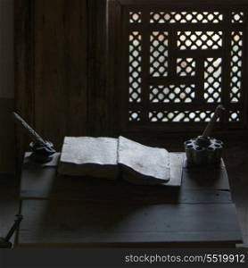 Close-up of an old book with ink well on table at Ben Youssef Madrasa, Medina, Marrakesh, Morocco