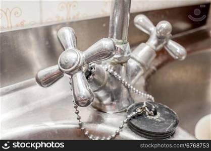 Close up of an old handle kitchen faucet
