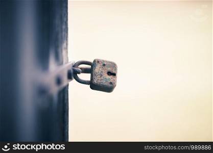 Close up of an old rusty padlock at a door, text space