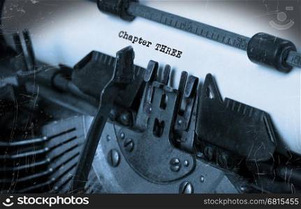 Close-up of an old typewriter with paper, perspective, selective focus, chapter three
