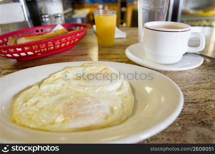 Close-up of an omelet on a plate with a cup of tea