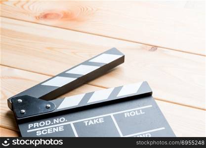 close-up of an open video clapper on wooden boards view of a candle