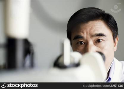 Close-up of an optometrist in front of an ophthalmoscope