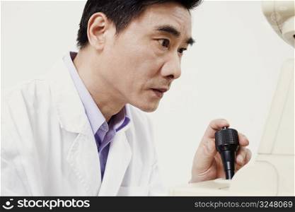 Close-up of an optometrist operating an ophthalmoscope