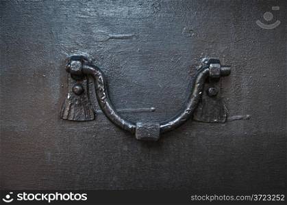 close-up of ancient doorknob of iron door