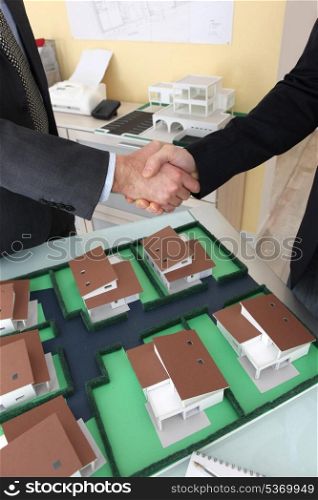 Close-up of architects shaking hands
