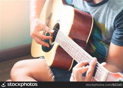 Close up of asian man playing guitar, Selective focus