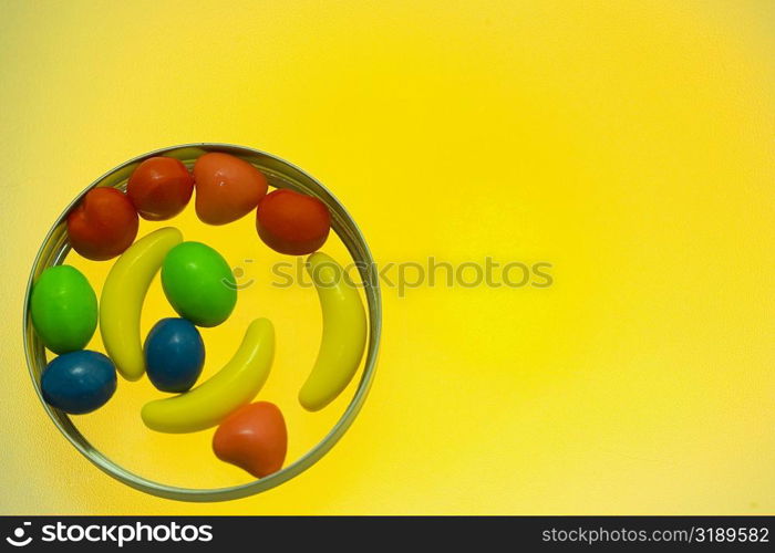 Close-up of assorted candies on a yellow background