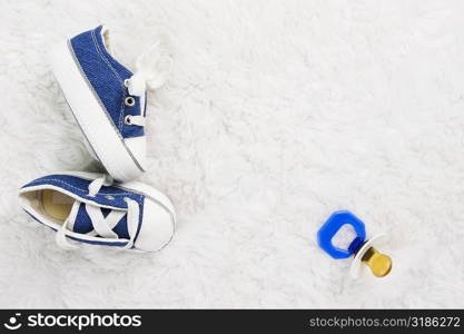 Close-up of baby booties and a pacifier