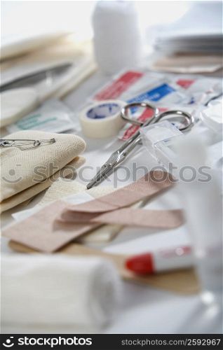 Close-up of bandages and medical tape with a pair of scissors