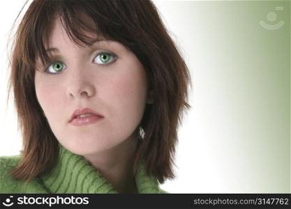 Close Up of Beautiful Teen Girl In Green Sweater. Dark hair and green eyes.