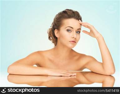 close up of beautiful woman lying on the mirror