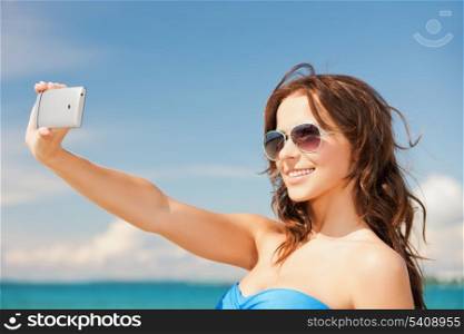 close up of beautiful woman on the beach with phone