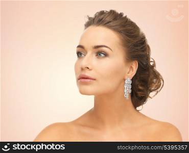 close up of beautiful woman wearing shiny diamond earrings