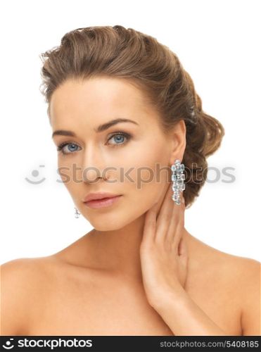 close-up of beautiful woman wearing shiny diamond earrings