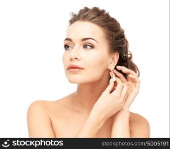 close-up of beautiful woman wearing shiny diamond earrings. woman wearing shiny diamond earrings