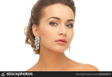close-up of beautiful woman wearing shiny diamond earrings. woman wearing shiny diamond earrings