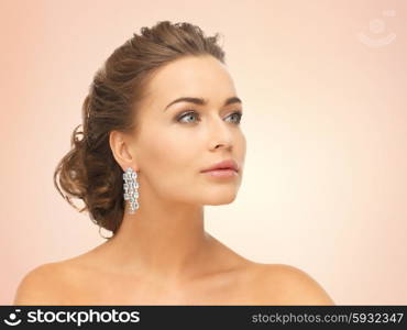 close up of beautiful woman wearing shiny diamond earrings. woman wearing shiny diamond earrings