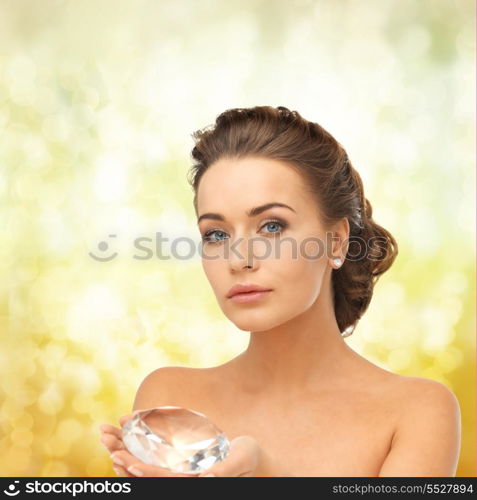 close-up of beautiful woman with earrings showing big diamond