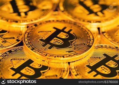 close up of bitcoins. close up of pile of golden bitcoins in backlight