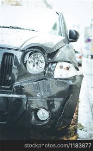 Close up of black damaged car, front view
