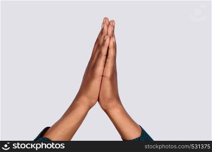 Close-up of black hands praying.