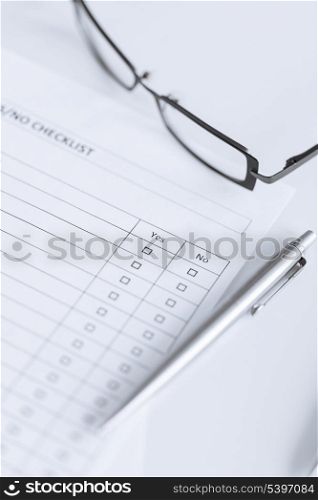 close up of blank questionnaire or form with eyeglasses