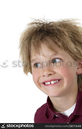 Close-up of blond boy looking sideways over white background