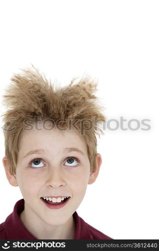 Close-up of blond boy looking up over white background