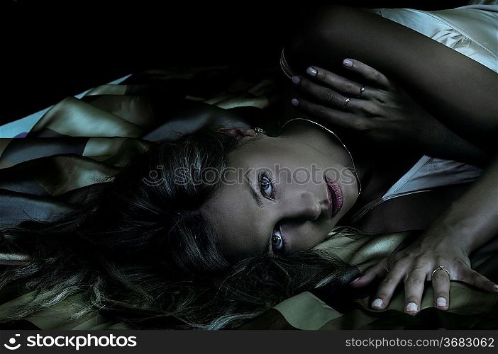 close up of blond woman laying down between the sheet