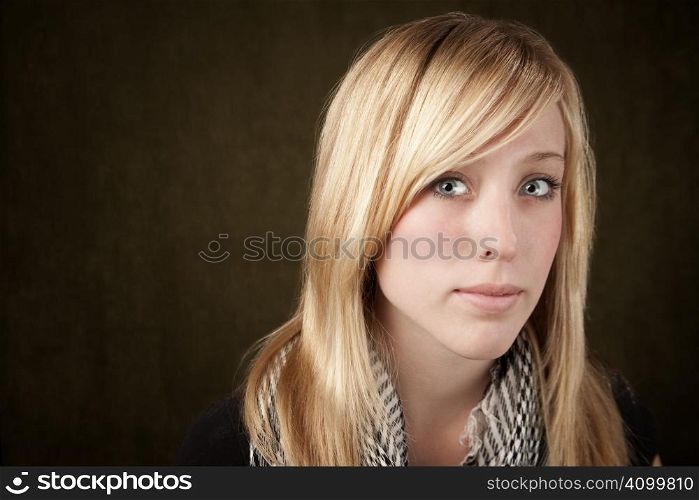 Close up of blonde girl focusing on her blue eyes