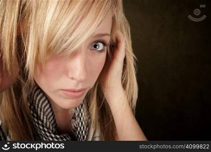 Close up of blonde girl focusing on her eye