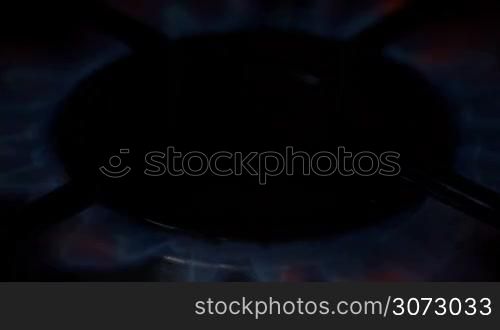 Close up of blue gas stove burner lit/turn off