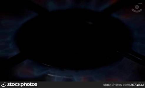 Close up of blue gas stove burner lit/turn off