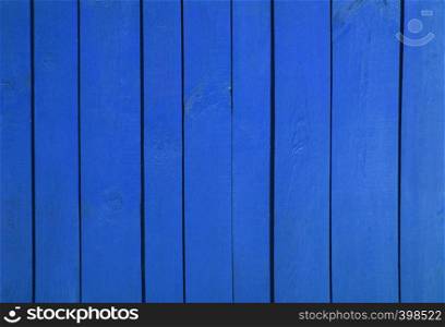 Close up of blue painted wooden fence panels.