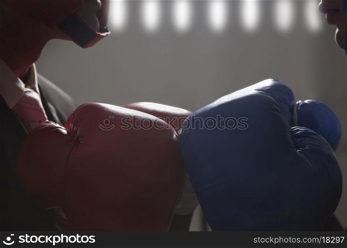 Close-up of boxing gloves worn by businessmen