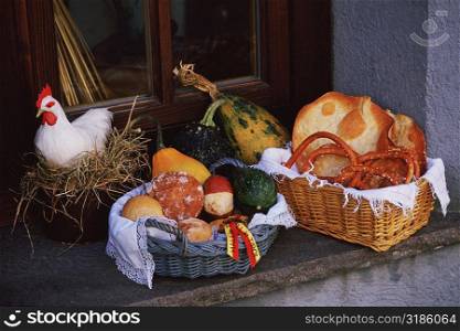 Close-up of bread in a wicker basket with a hen in a nest, Hall, Austria