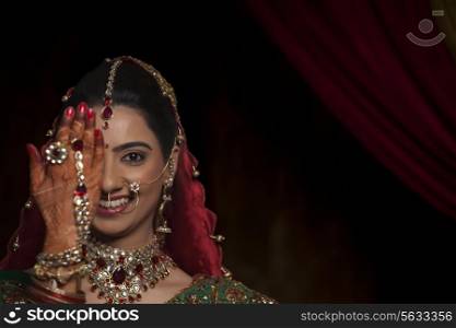 Close up of bride with one hand in front of her eye