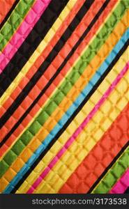 Close-up of bright colorful striped quilted vintage fabric.