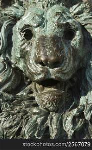 Close-up of bronze lion statue turning green from oxidation in Venice, Italy.