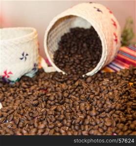 Close up of Brown Coffee Beans Pouring Out From White Wicker Bowl