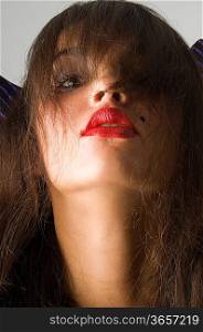 close up of brunette with red lips and long looking like a witch