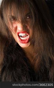 close up of brunette with teeth like a vampire and red eyes